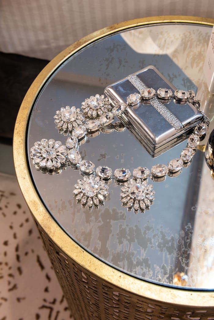 services-04 From above of silver necklace with floral ornament and diamonds on metal box on table in house room